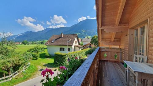 a balcony with a view of a house at Kienberghäusle in Pfronten