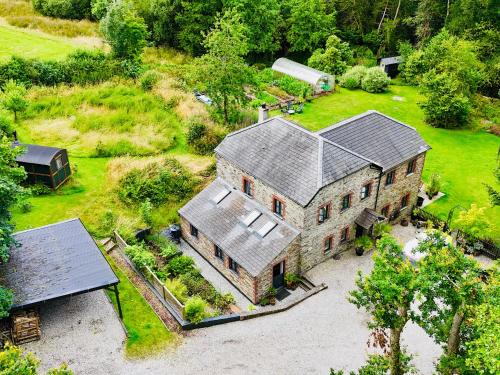 an aerial view of a large house with a barn at The Leat at The Old Mill in Tavistock