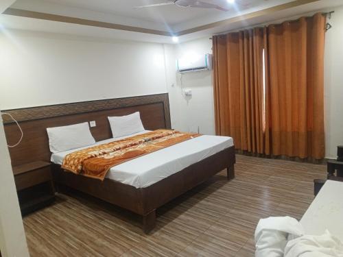 a bedroom with a bed in a room at Cecil homes hotel in Murree