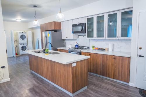 a kitchen with wooden cabinets and a white counter top at Executive 1BR Downtown POS with ensuite bath in Port-of-Spain