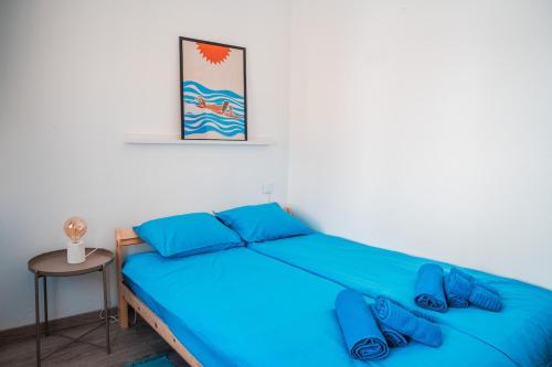 a bedroom with a blue bed with blue pillows at Blue Bay in Lagos