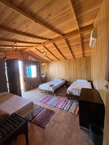 a large room with two beds and a tv in it at Anne Nuweiba in Nuweiba