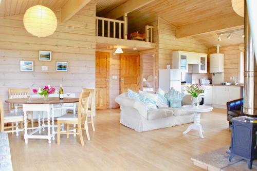 a living room with a couch and a table at Curlew Lodge in Dumfries