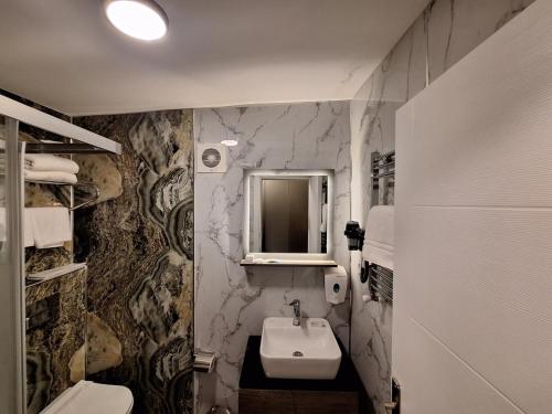 a bathroom with a sink and a mirror at The Best City Kadikoy in Istanbul