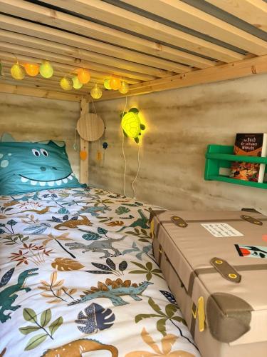 a bedroom with a bed with a cat comforter at Le Ptit studio du vieux moulin in Rochefort