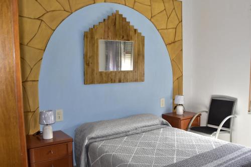 a bedroom with a bed and a mirror on the wall at Lo Racó del Delta in Sant Jaume d'Enveja
