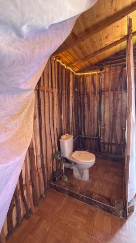 a bathroom with a toilet in a wooden structure at Anne Nuweiba in Nuweiba