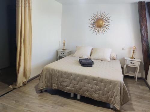 a bedroom with a bed with a suitcase on it at Maison d'Hôtes La Grange in Salers