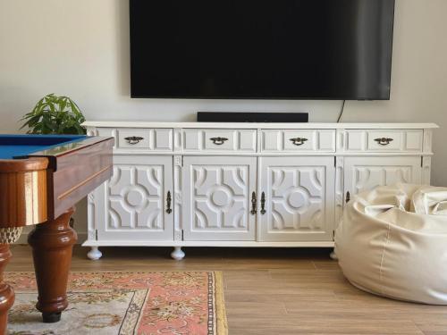 a white entertainment center with a flat screen tv on it at Villa Rosa in Melgaço