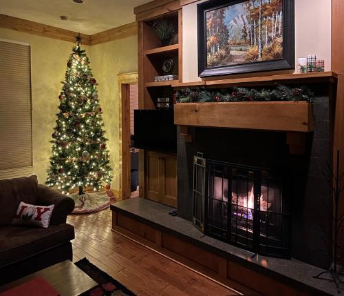 a living room with a christmas tree and a fireplace at Powder Mtn Trapper Lodge TR1 Ski Retreat Game Rm in Eden