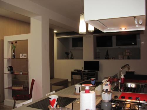 a kitchen with a counter top with a sink and a stove at Folco Studio Apartment in Piazza Armerina