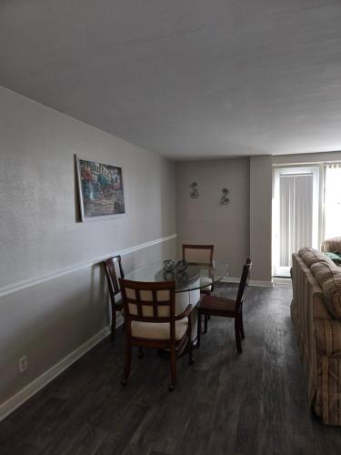a living room with a table and chairs and a couch at Convenient Downtown Apartment in Saint Louis