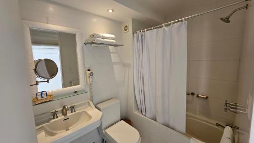 a bathroom with a sink and a toilet and a shower at Le Grand Hotel Ilo in Ilo