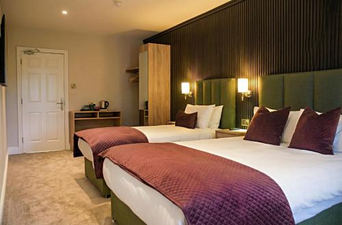 a hotel room with two beds in a room at Kerry Coast Hotel in Cahersiveen