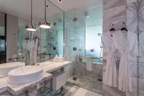 a bathroom with two sinks and a tub and a shower at Palms Place No Resort fees with Balcony in Las Vegas
