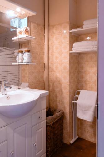 a bathroom with a sink and a mirror at Charming apartment in Porto-Vecchio in Porto-Vecchio