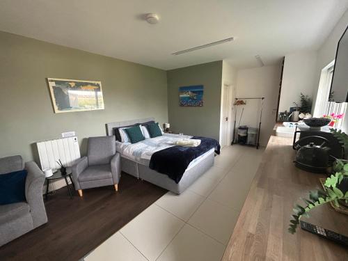 a bedroom with a bed and a chair in it at Appletree Cottage in Waterford