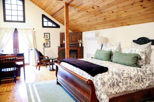 a bedroom with a bed and a desk in a room at Stonecroft Inn in Ledyard Center