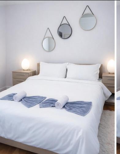 a bedroom with a white bed with two towels on it at Dušanovac Panorama House - veliko dvoriste, 2 rostilja, pogled na Rasku in Raška