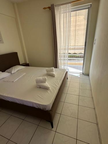 a bedroom with a bed with two towels on it at Luxury Beach House 2 in Xiropigado