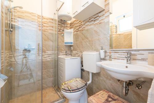 a bathroom with a toilet and a sink and a shower at Blue horizont in Mlini