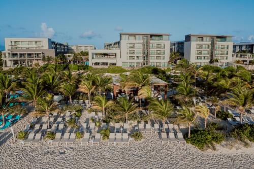 an aerial view of a resort with palm trees and a pool at Catalonia Grand Costa Mujeres All Suites & Spa - All Inclusive in Cancún