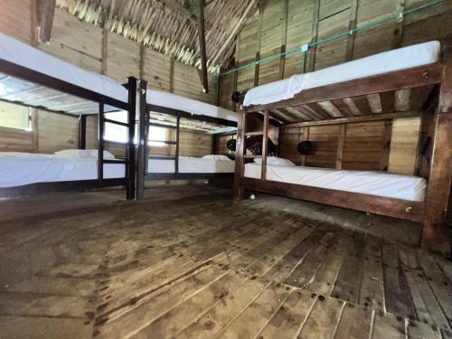 a room with two bunk beds and a wooden floor at Casa en el agua in Tintipan Island