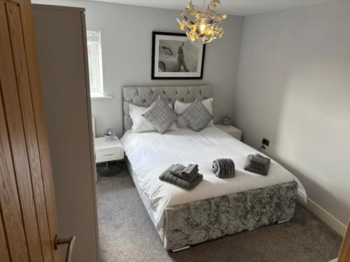 a bedroom with a bed with two towels on it at A beautiful 2-bedroom Apartment in Skegness