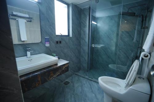 a bathroom with a sink and a toilet and a shower at Hotel Crown Park Ltd in Sylhet