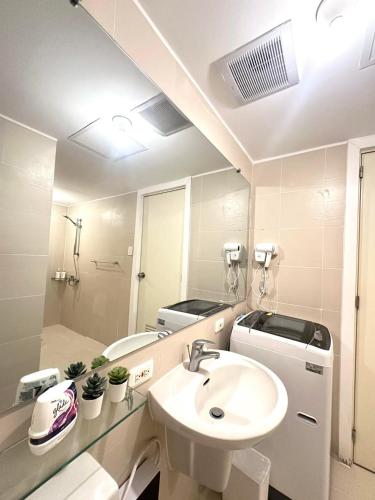 a bathroom with a sink and a mirror at 2 Bed Studio with Panoramic Sunrise View & BigBalcony in San Fernando