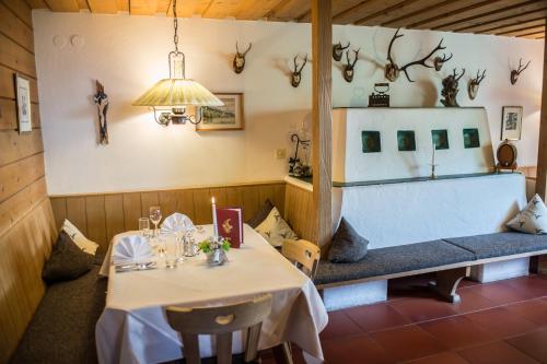 a dining room with a table and a bench with candles at Hotel Helga in Seefeld in Tirol