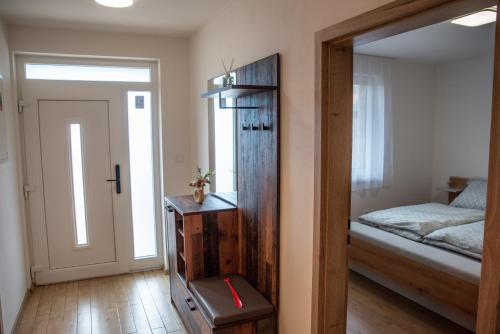 a room with a bedroom with a bed and a mirror at La Palma Gúta in Kolárovo
