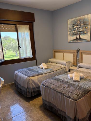 a room with three beds and a window at CASA JESUS in Abiego