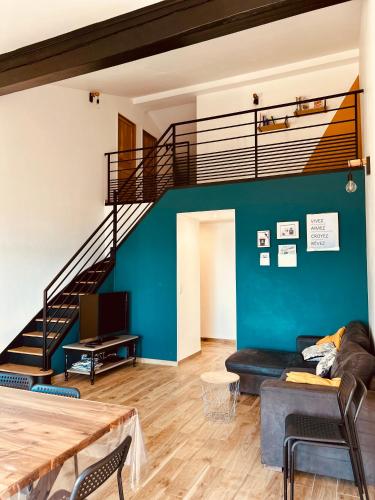 a living room with a couch and a staircase at Duplex face à la mer in Saint-Florent