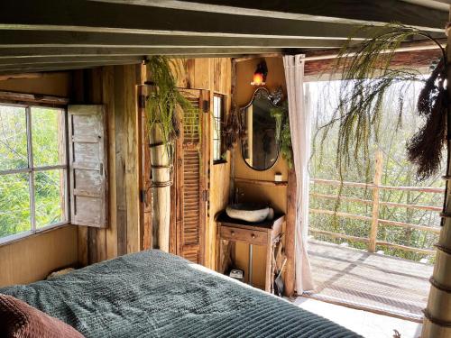 a bedroom with a bed and a mirror and a window at Bamboo Lodge Groningen in Groningen