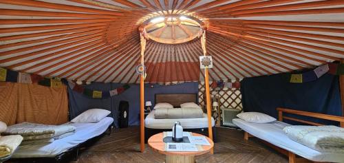 a room with two beds in a tent at Chez Jo et Mel - Gite et Yourtes in Bannost