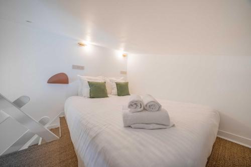 a bedroom with a white bed with towels on it at Studio in a residence with pool - Saint-Tropez in Saint-Tropez