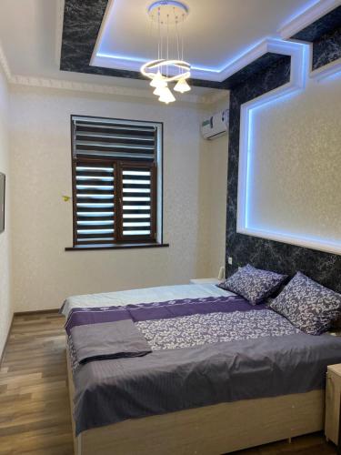 a bedroom with a bed and a window at Hotel KASIMOV in Podan