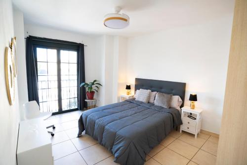 a bedroom with a large bed and a window at Estrella del Sur in Torremolinos