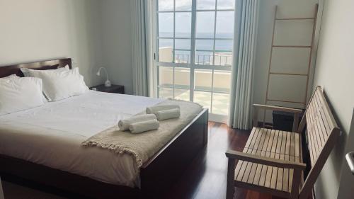 a bedroom with a bed with two towels on it at Maribel's Place in Funchal
