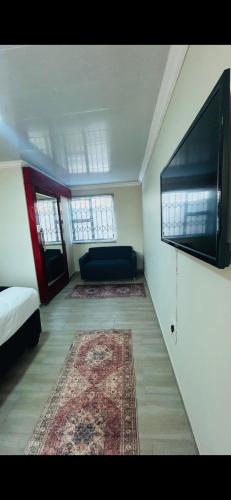 a room with a bed and a flat screen tv at Iyana Lodge in Grasmere