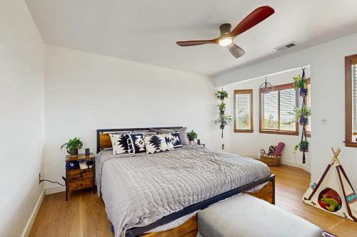 a bedroom with a bed and a ceiling fan at Boat, Hike, Fish! Summer Cabin Near Lake Arrowhead in Running Springs