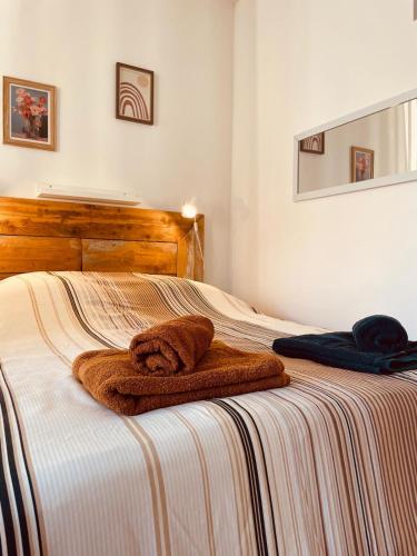 a brown towel is sitting on a bed at Le Val Claret in Antibes