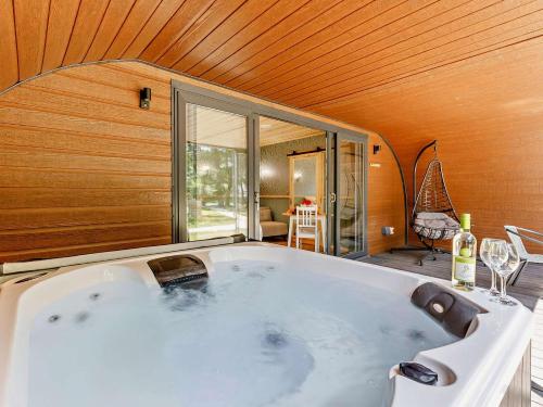 a large bath tub in a room with a window at 1 Bed in Okehampton oc-92384 in Okehampton