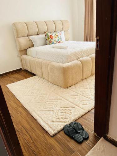a large bed in a bedroom with a rug on the floor at Eunas homestay in Eldoret