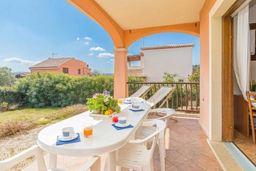 a white table and chairs on the balcony of a house at Le Dimore di Nettuno in Olbia