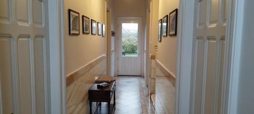 a hallway with two doors and a table in a room at Wervik-94 in Wervik