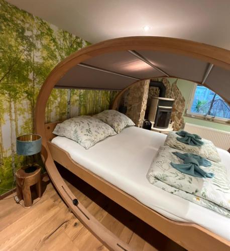 a large bed in a room with an archivist at BioNestlein Premium Apartments mit Biosauna, Wintergarten & exklusiver Bio-Verpflegung in Löffingen