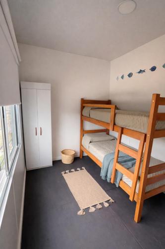 a bedroom with two bunk beds and a window at Casa Tetis in La Floresta