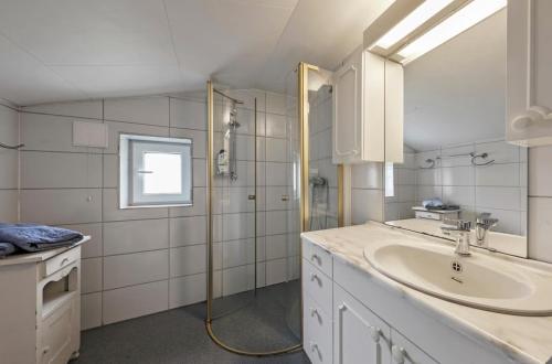 a white bathroom with a sink and a shower at Staurset gård in Mittet